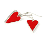 Red heart-shaped earrings on a white background